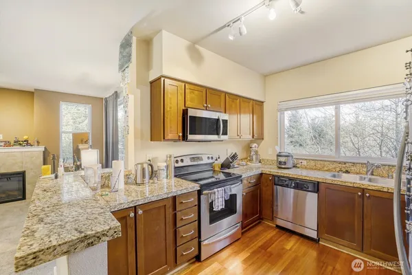 a kitchen with a sink stove top oven and microwave