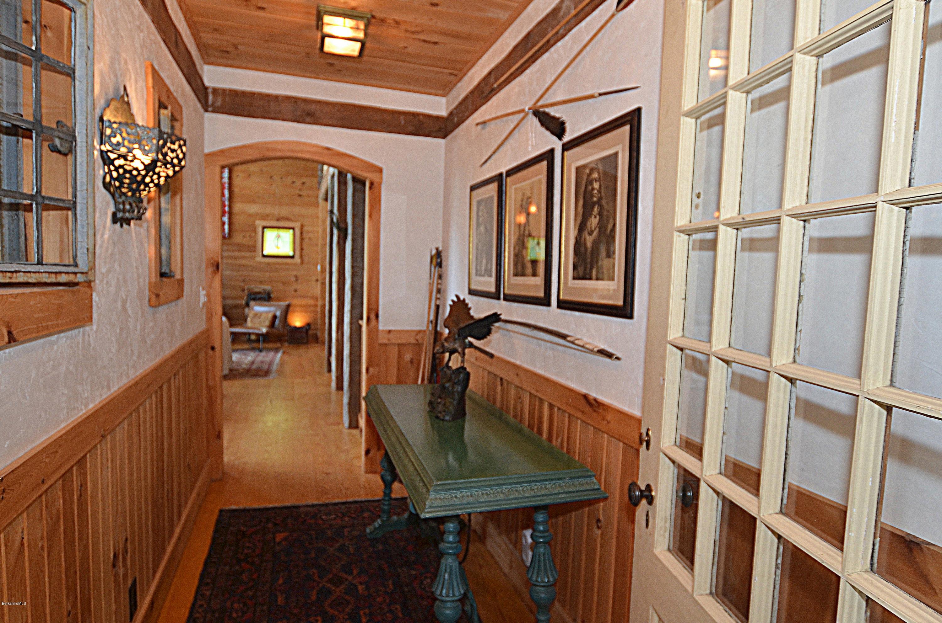 1297 Fred Snow Road Becket, MA 01223 - Photo 11 of 41 a view of a balcony with furniture and wooden floor