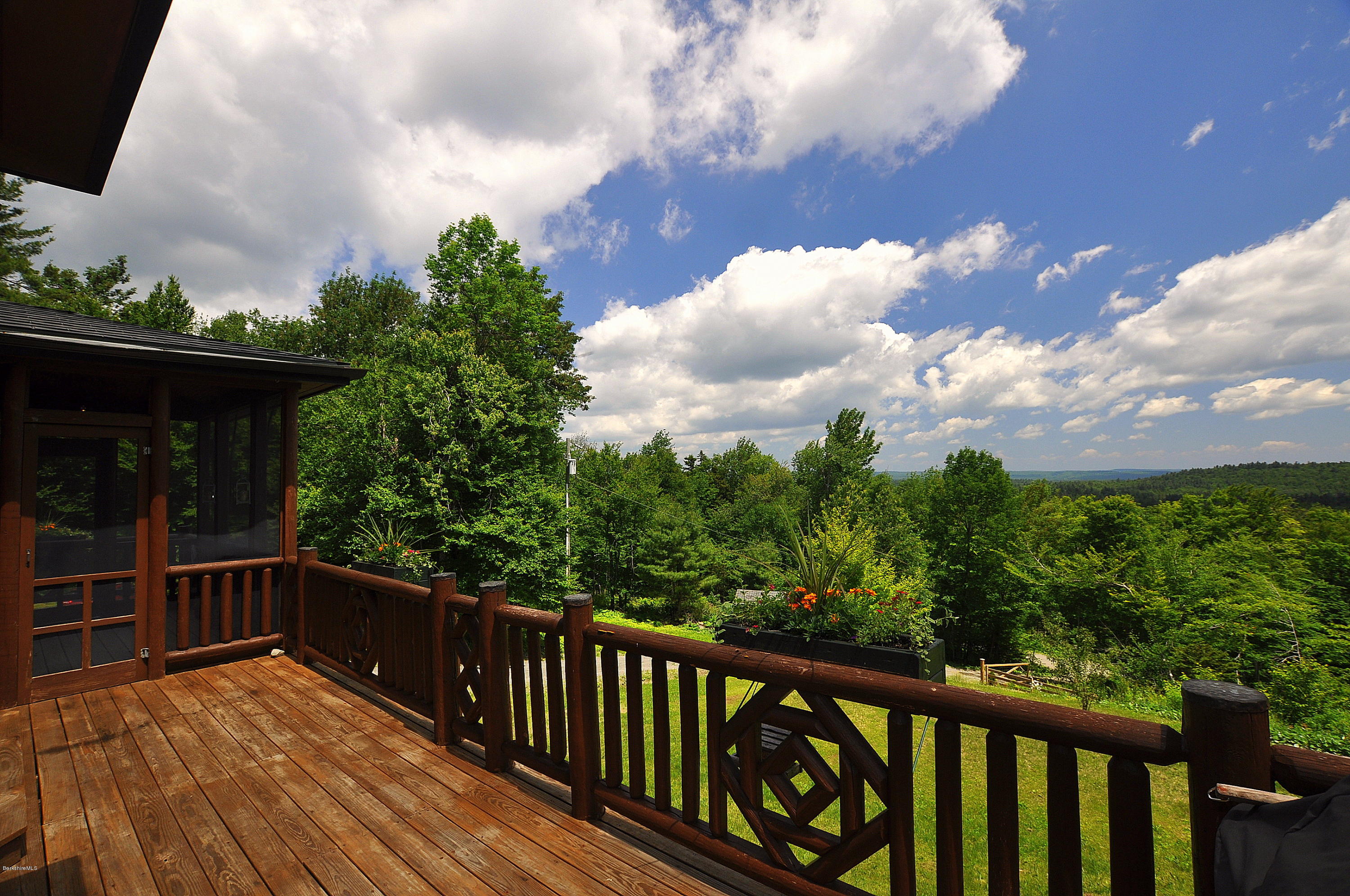 1297 Fred Snow Road Becket, MA 01223 - Photo 3 of 41 a balcony with wooden floor