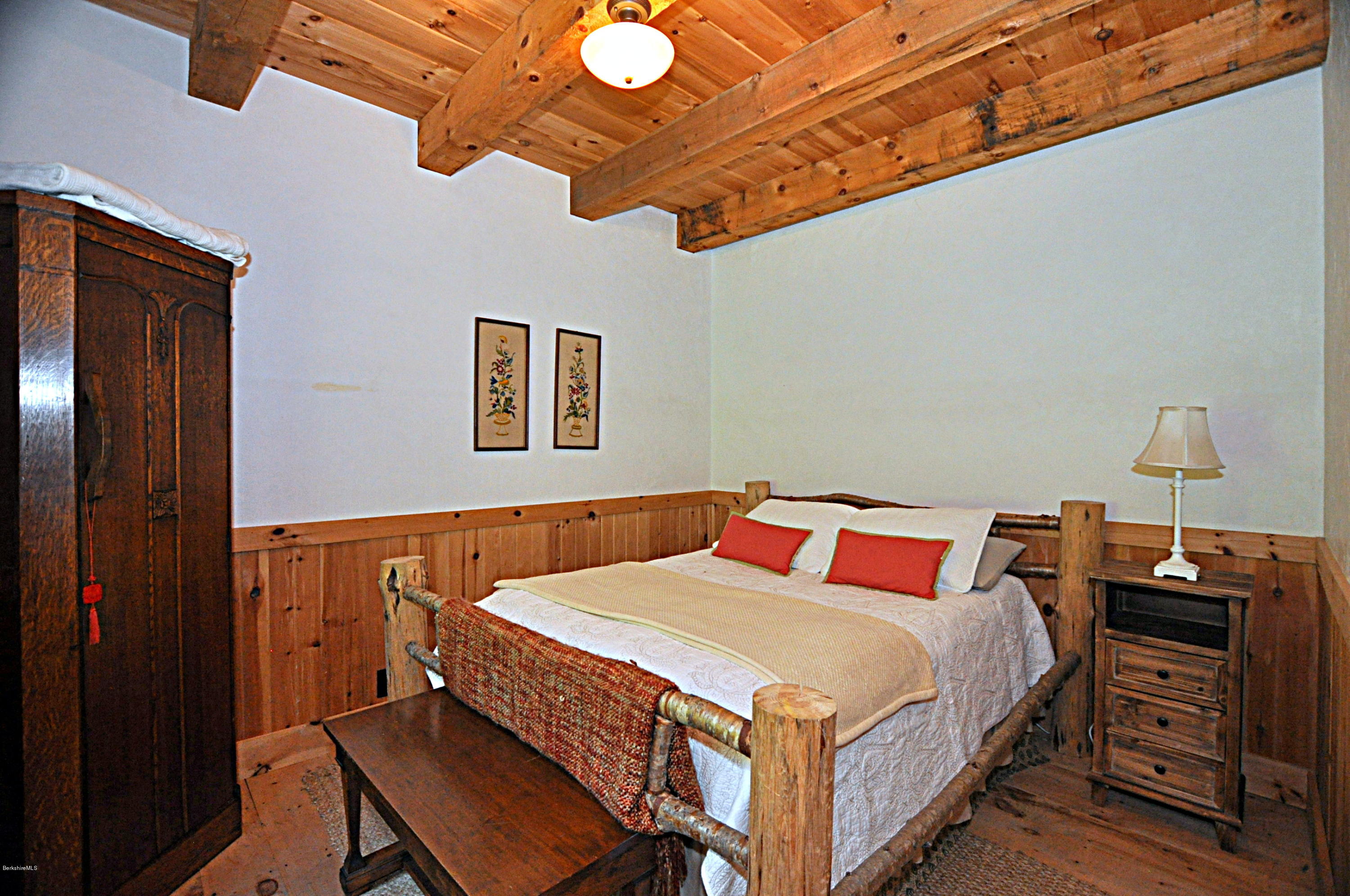 1297 Fred Snow Road Becket, MA 01223 - Photo 21 of 41 a bedroom with a bed and a dresser