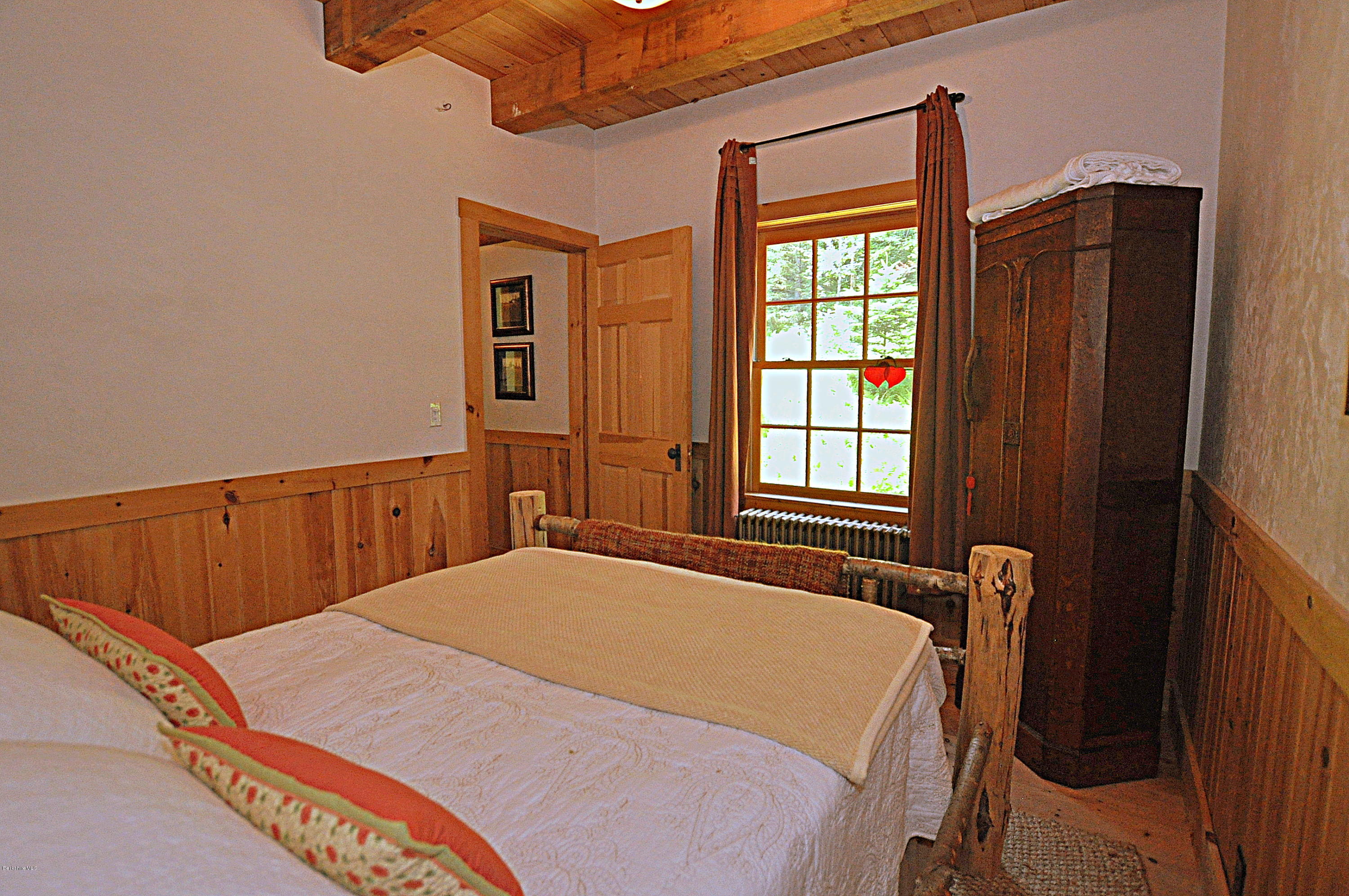 1297 Fred Snow Road Becket, MA 01223 - Photo 22 of 41 a bedroom with a bed and a window