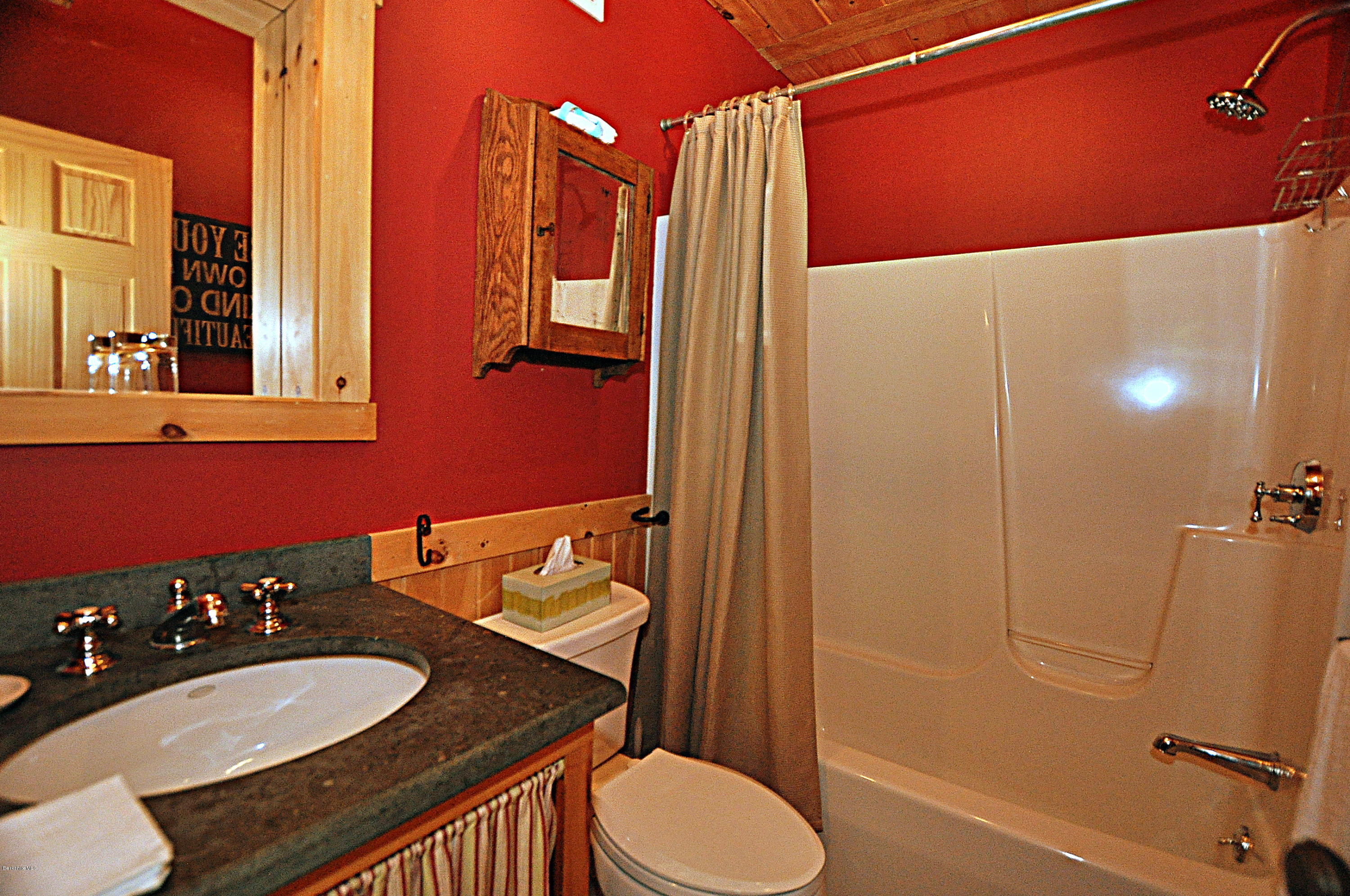 1297 Fred Snow Road Becket, MA 01223 - Photo 23 of 41 a bathroom with a sink vanity mirror and toilet