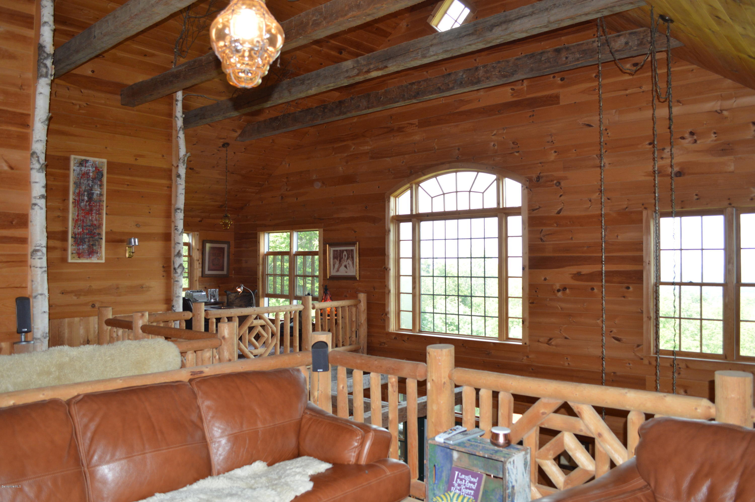 1297 Fred Snow Road Becket, MA 01223 - Photo 32 of 41 a view of a dining room with furniture a chandelier and wooden floor