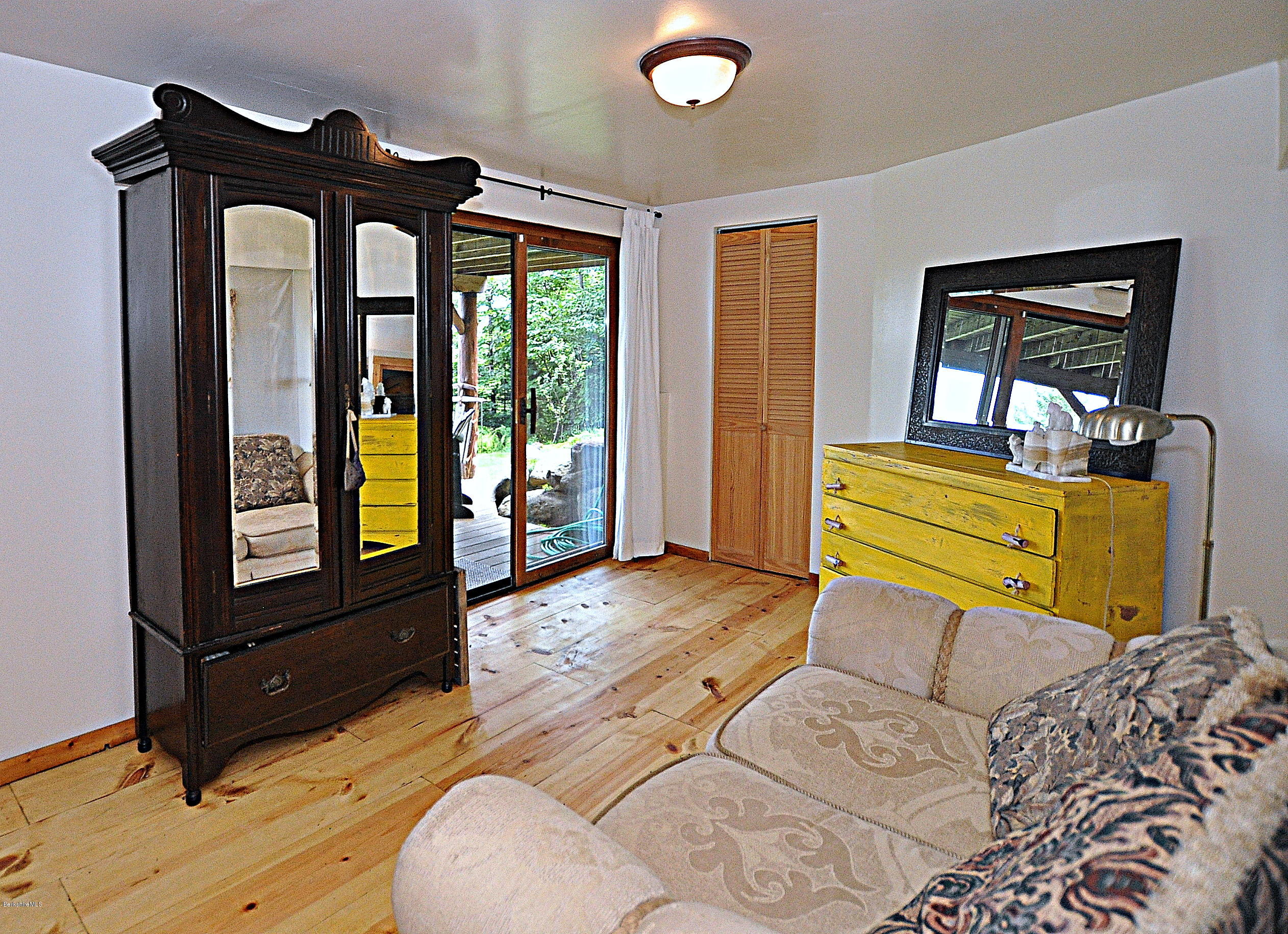 1297 Fred Snow Road Becket, MA 01223 - Photo 33 of 41 a bedroom with a bed and wooden floor