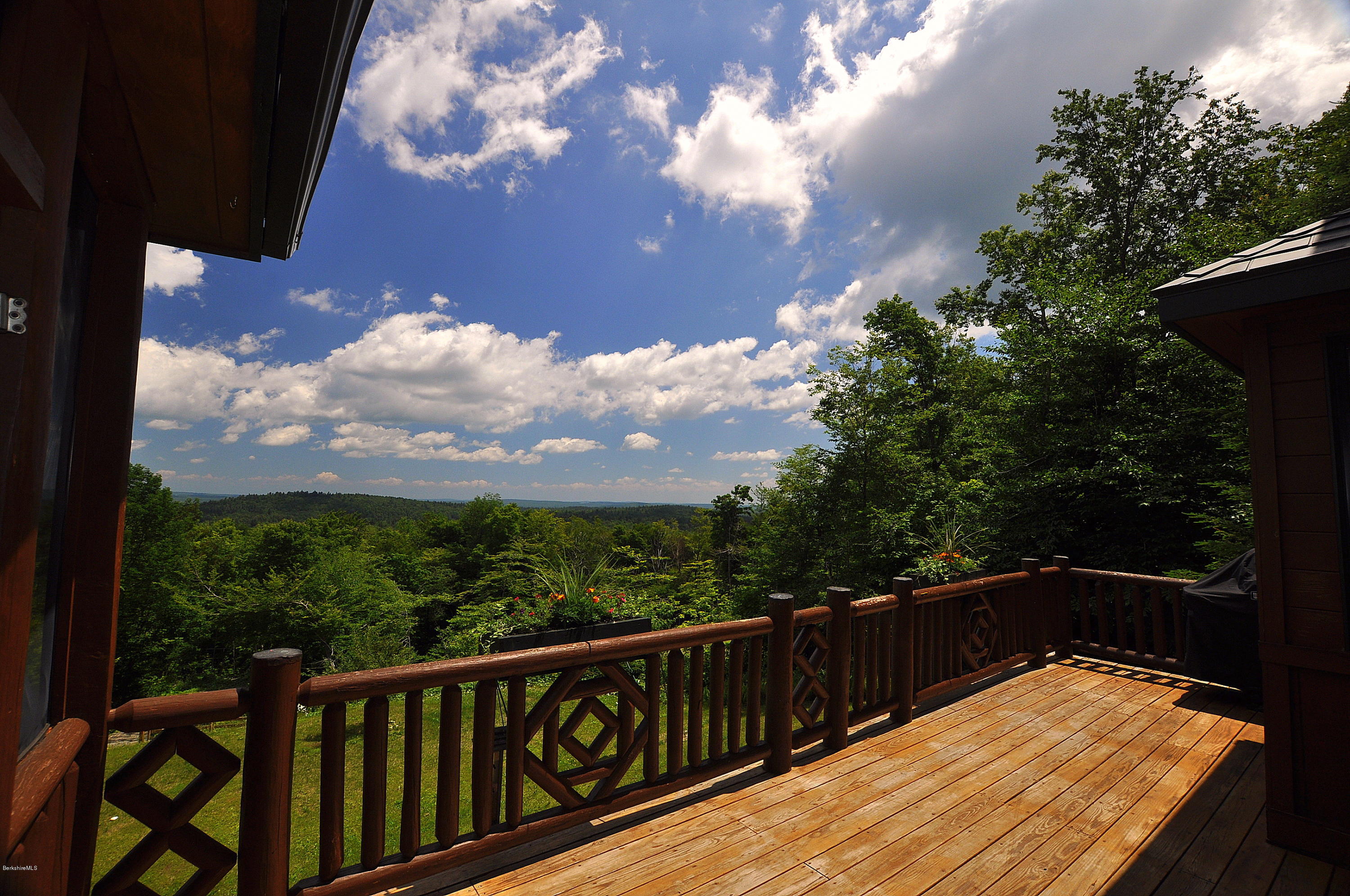 1297 Fred Snow Road Becket, MA 01223 - Photo 5 of 41 a view of balcony with wooden floor and fence