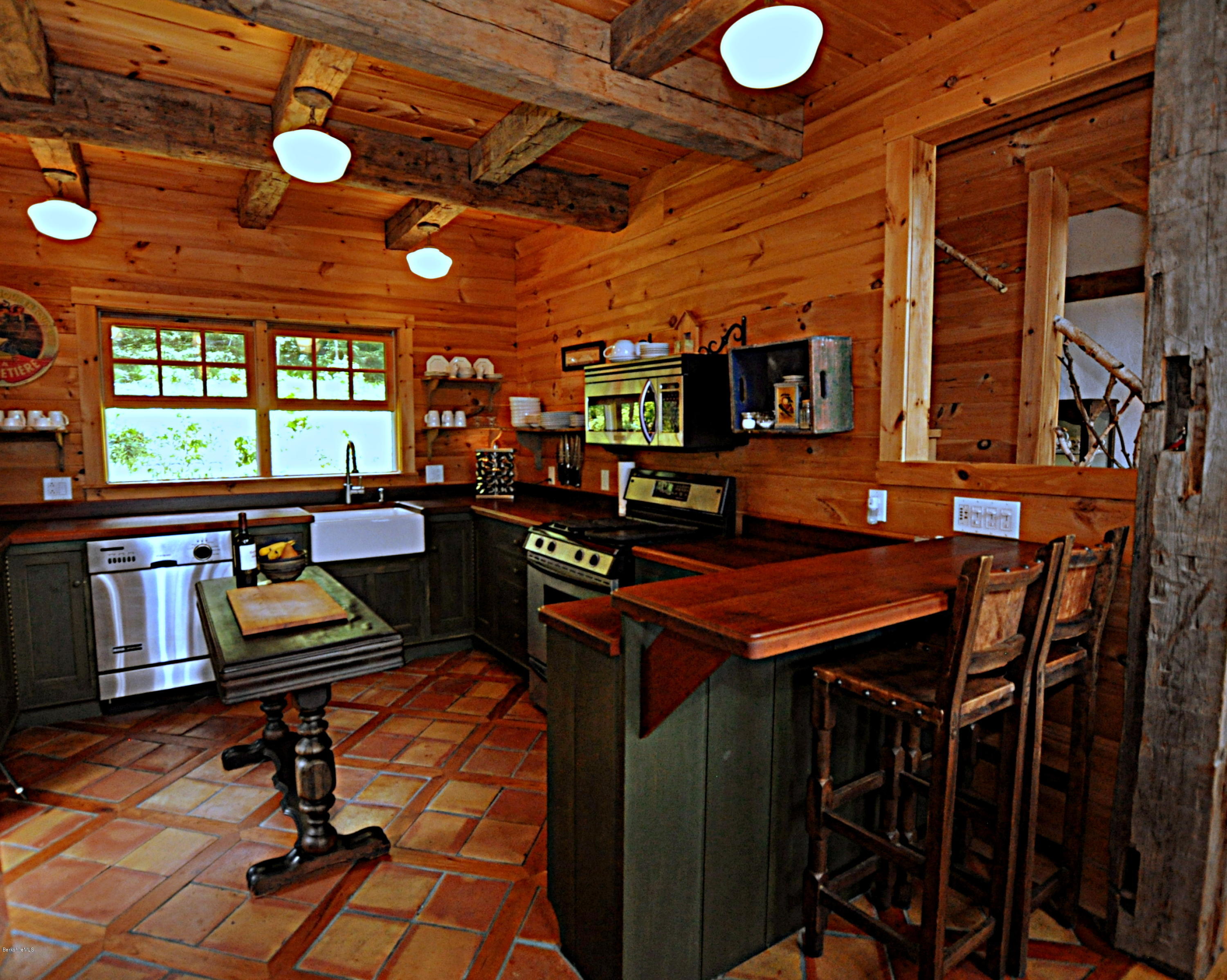 1297 Fred Snow Road Becket, MA 01223 - Photo 7 of 41 a room with lots of chairs and appliances