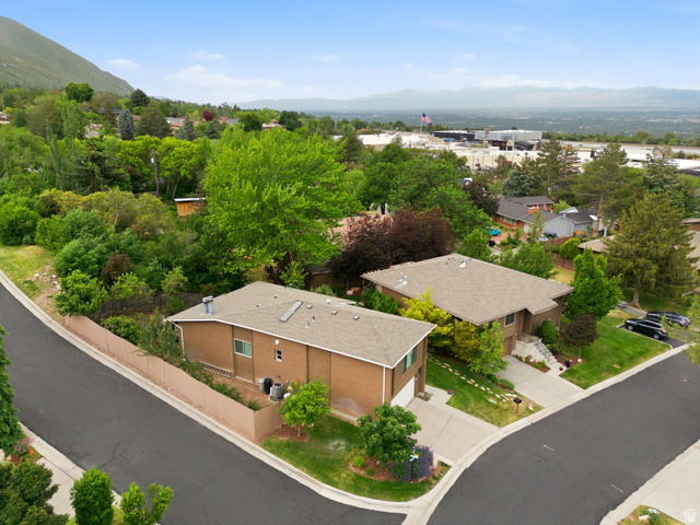 3674 Oak Rim Way Salt Lake City, UT 84109 - Photo 41 of 47 Brick exterior residence featuring a two-car driveway and mature landscaping