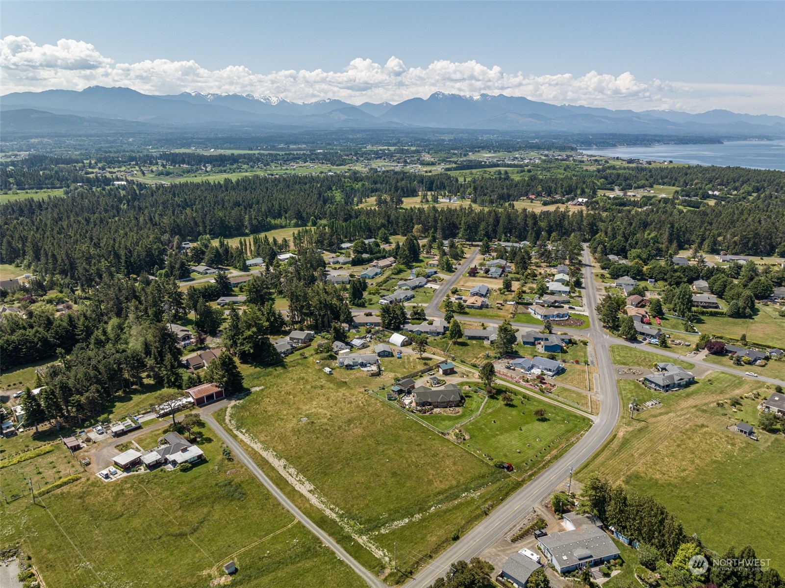 999 West Nelson Road, Unit B Sequim, WA 98382 - Photo 16 of 18 an aerial view of residential houses with outdoor space