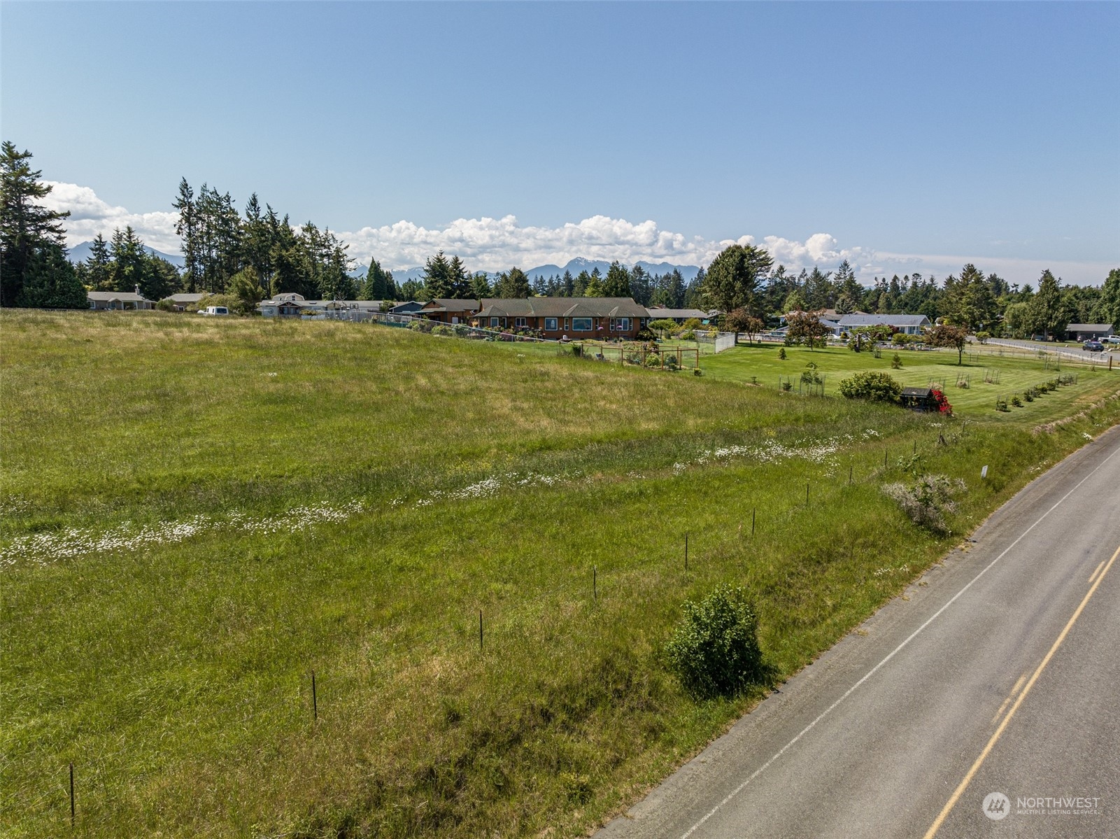 999 West Nelson Road, Unit B Sequim, WA 98382 - Photo 5 of 18 a view of a lake with houses in the background