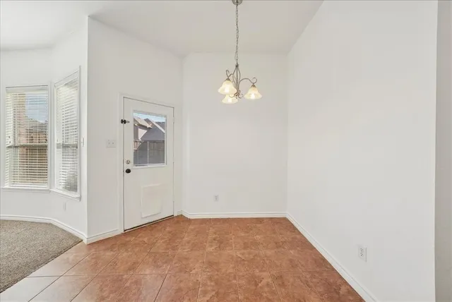 an empty room with windows and entrance