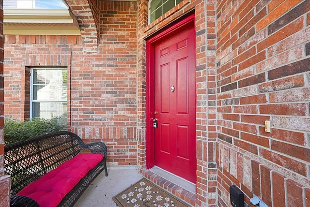a front view of a house with a red gate
