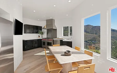 a dining room with a table and chairs