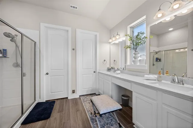 a spacious bathroom with a double vanity sink and a mirror