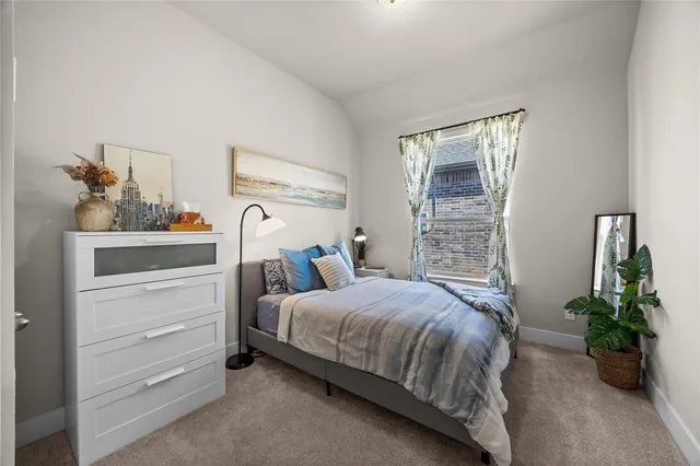 a bedroom with a bed and potted plant