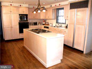 552 Bartram Road Moorestown, NJ 08057 - Photo 4 of 6 a kitchen with a sink a microwave a stove and refrigerator