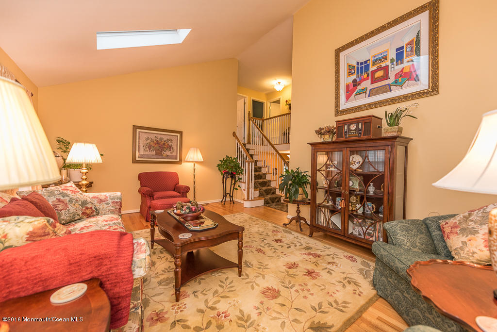 25 North Westfield Road Howell, NJ 07731 - Photo 12 of 25 a living room with furniture a rug and a wall painting