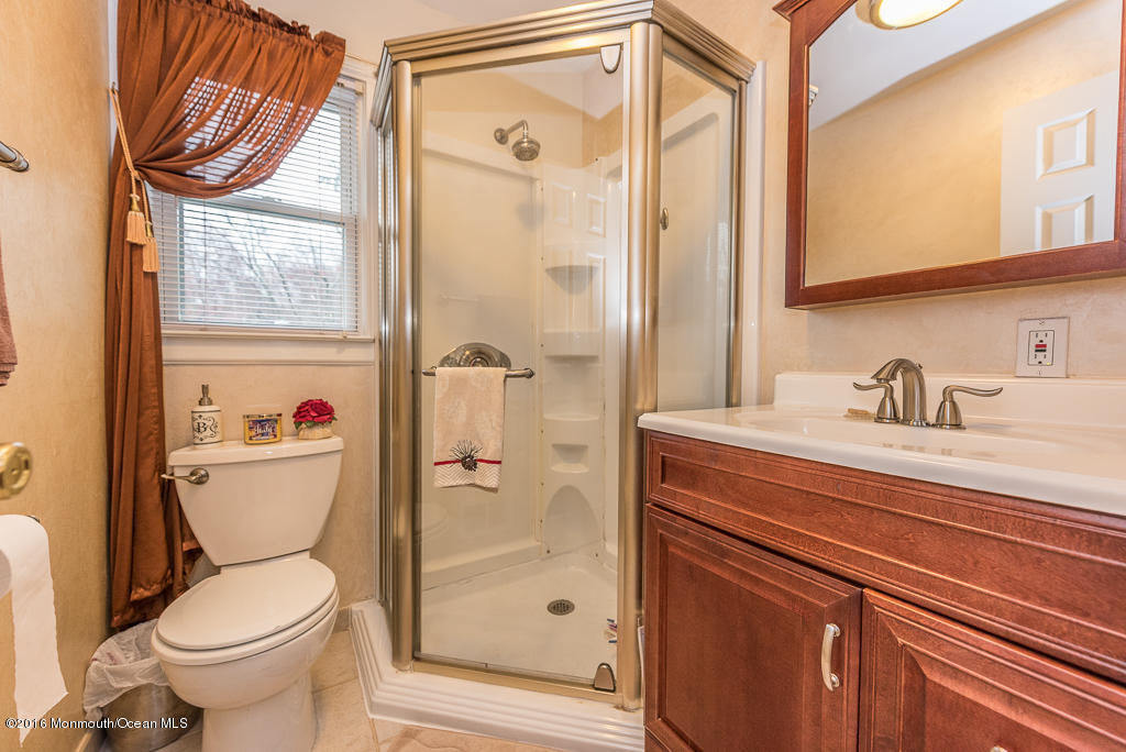 25 North Westfield Road Howell, NJ 07731 - Photo 16 of 25 a bathroom with a toilet a sink and a window