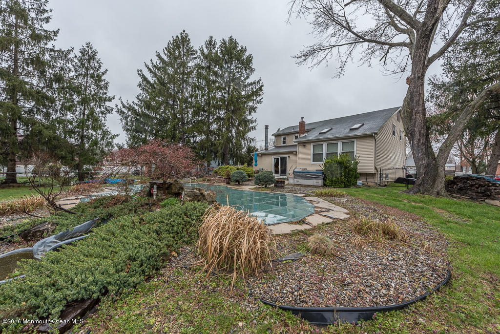 25 North Westfield Road Howell, NJ 07731 - Photo 22 of 25 a view of a white house with a yard potted plants and large tree