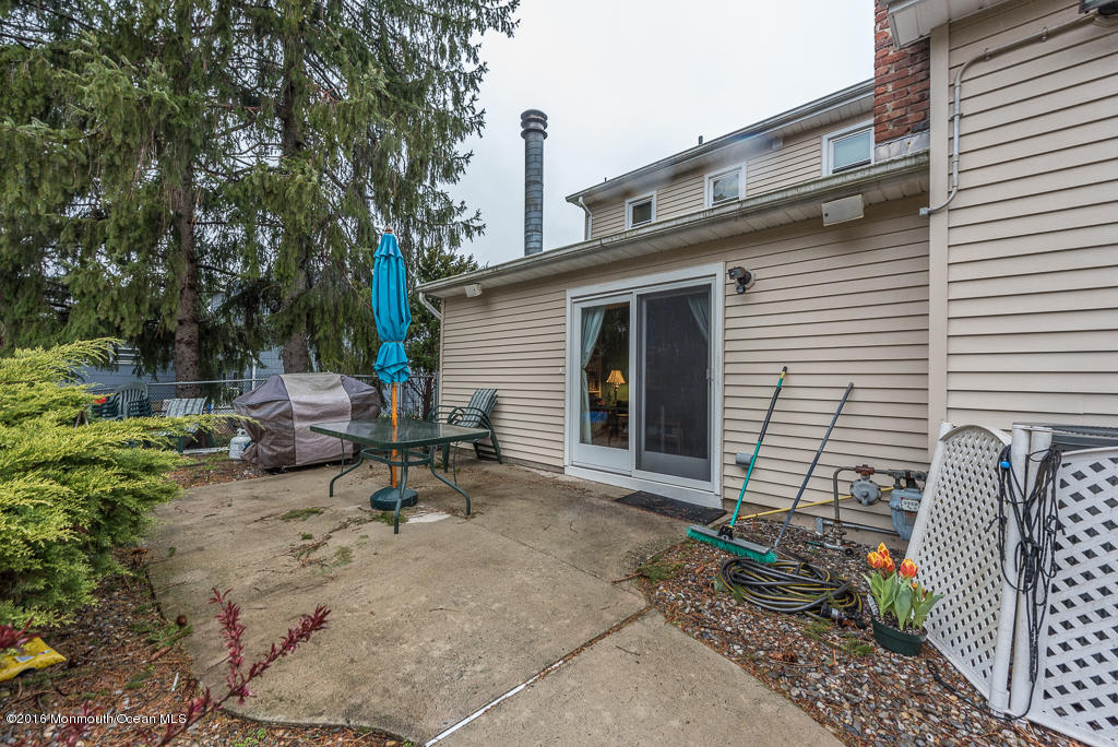 25 North Westfield Road Howell, NJ 07731 - Photo 25 of 25 a view of backyard with a table and chairs and potted plants