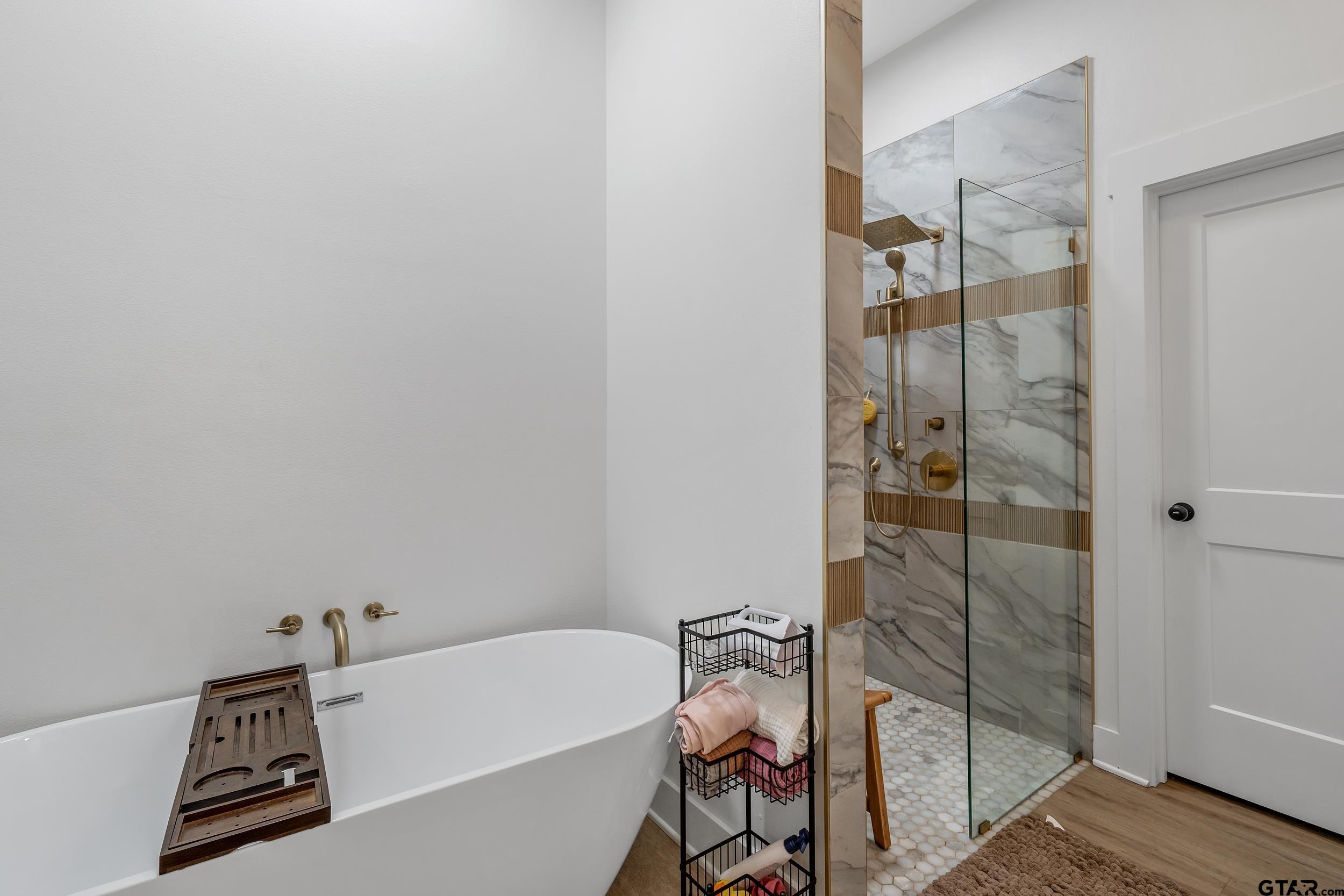 16837 Wilson Road Tyler, TX 75707 - Photo 22 of 44 a bathroom with a bathtub and shower