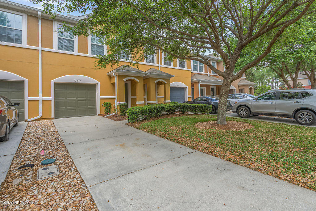 12940 Spring Rain Road Jacksonville, FL 32258 - Photo 1 of 20 a front view of a house with garden