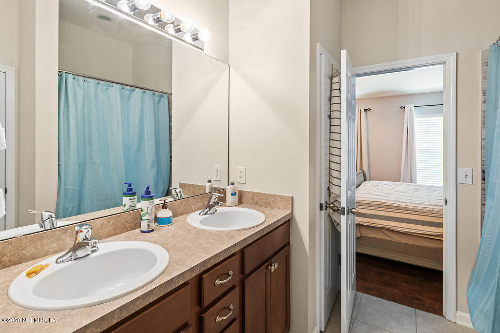 12940 Spring Rain Road Jacksonville, FL 32258 - Photo 11 of 20 a bathroom with a sink and a mirror