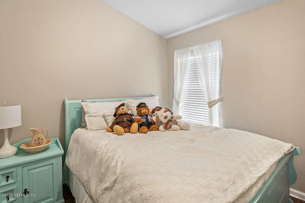 12940 Spring Rain Road Jacksonville, FL 32258 - Photo 12 of 20 a bedroom with a bed and a window