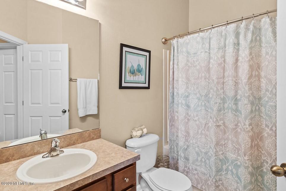 12940 Spring Rain Road Jacksonville, FL 32258 - Photo 13 of 20 a bathroom with a sink mirror and a toilet