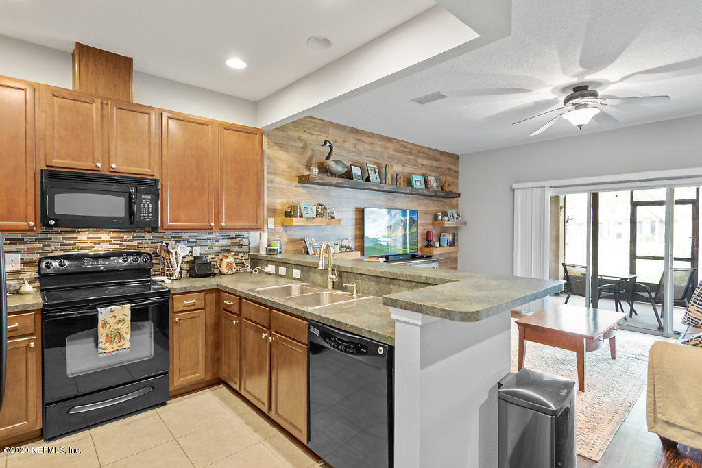 12940 Spring Rain Road Jacksonville, FL 32258 - Photo 4 of 20 a kitchen with stainless steel appliances granite countertop a sink stove and refrigerator