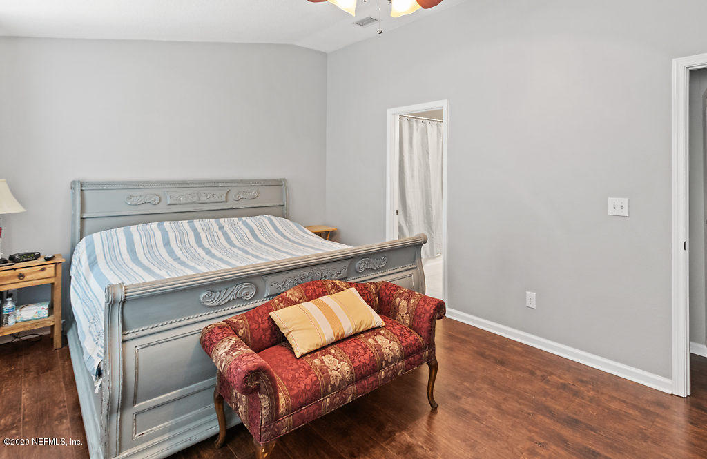 12940 Spring Rain Road Jacksonville, FL 32258 - Photo 8 of 20 a bedroom with a bed and a couch