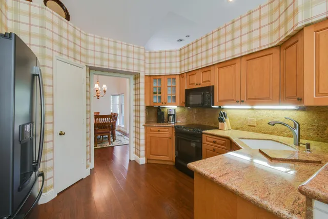 a bathroom with a granite countertop sink and a toilet