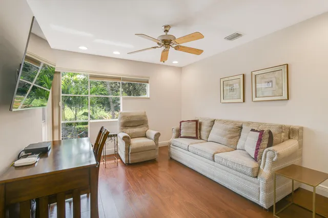 a view of a bedroom with a furniture and a ceiling fan