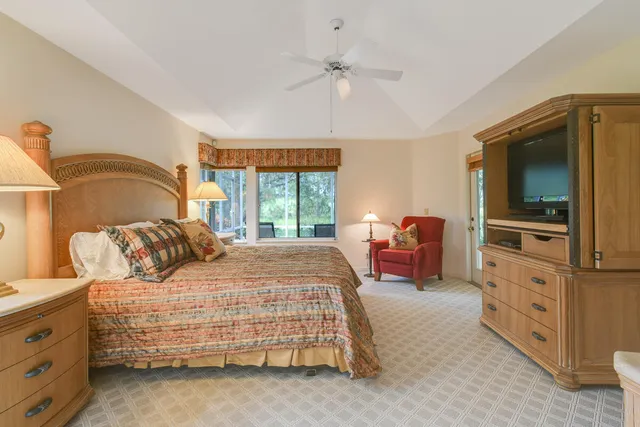 a bedroom with two beds and a large window