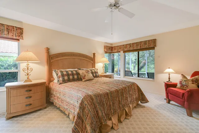 a bed room with two bed and a large window