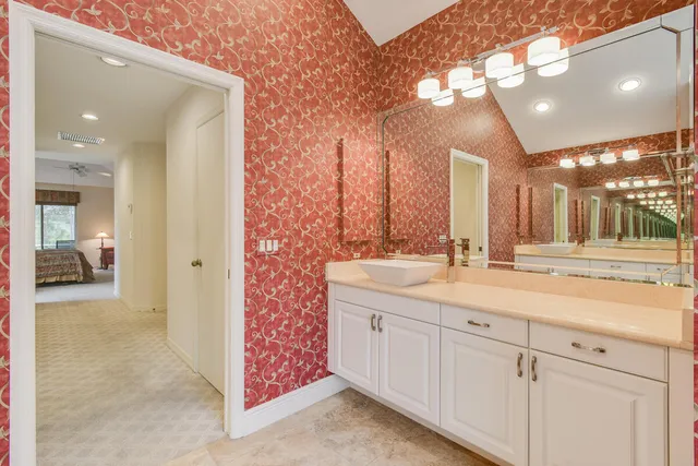 a bathroom with a granite countertop sink a shower and a mirror
