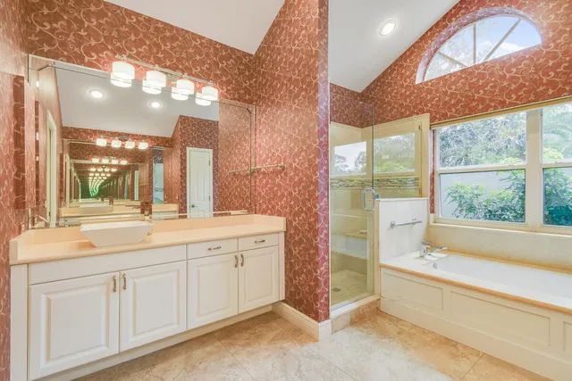 a bathroom with a shower and a glass door