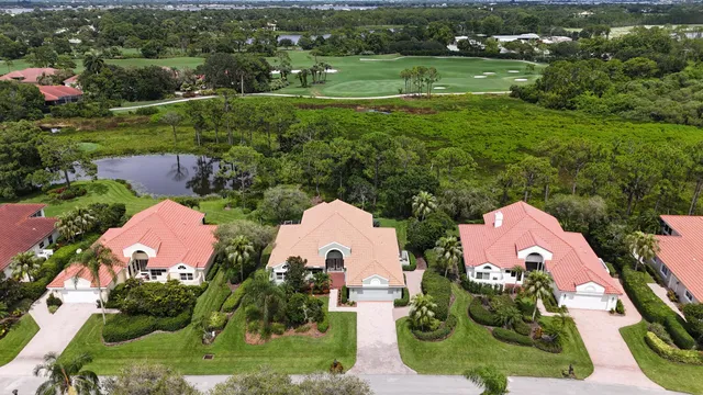 a view of a brick building with many windows and a yard