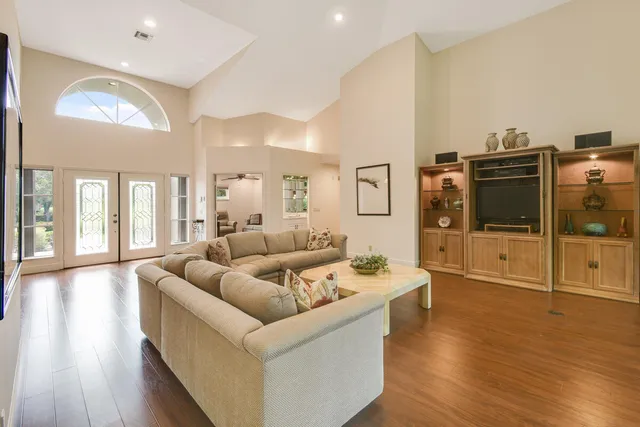 a living room with furniture and large window