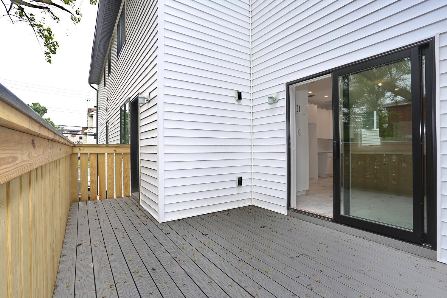 37 Ewing Avenue, Unit 202 Spring Valley, NY 10977 - Photo 11 of 44 a view of a porch with wooden floor and floor to ceiling window