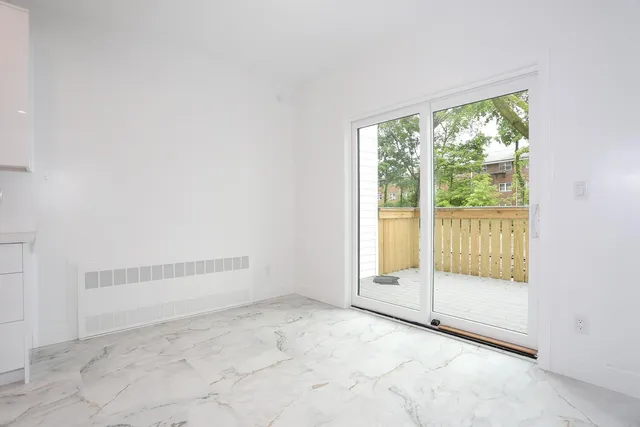 an empty room with large windows