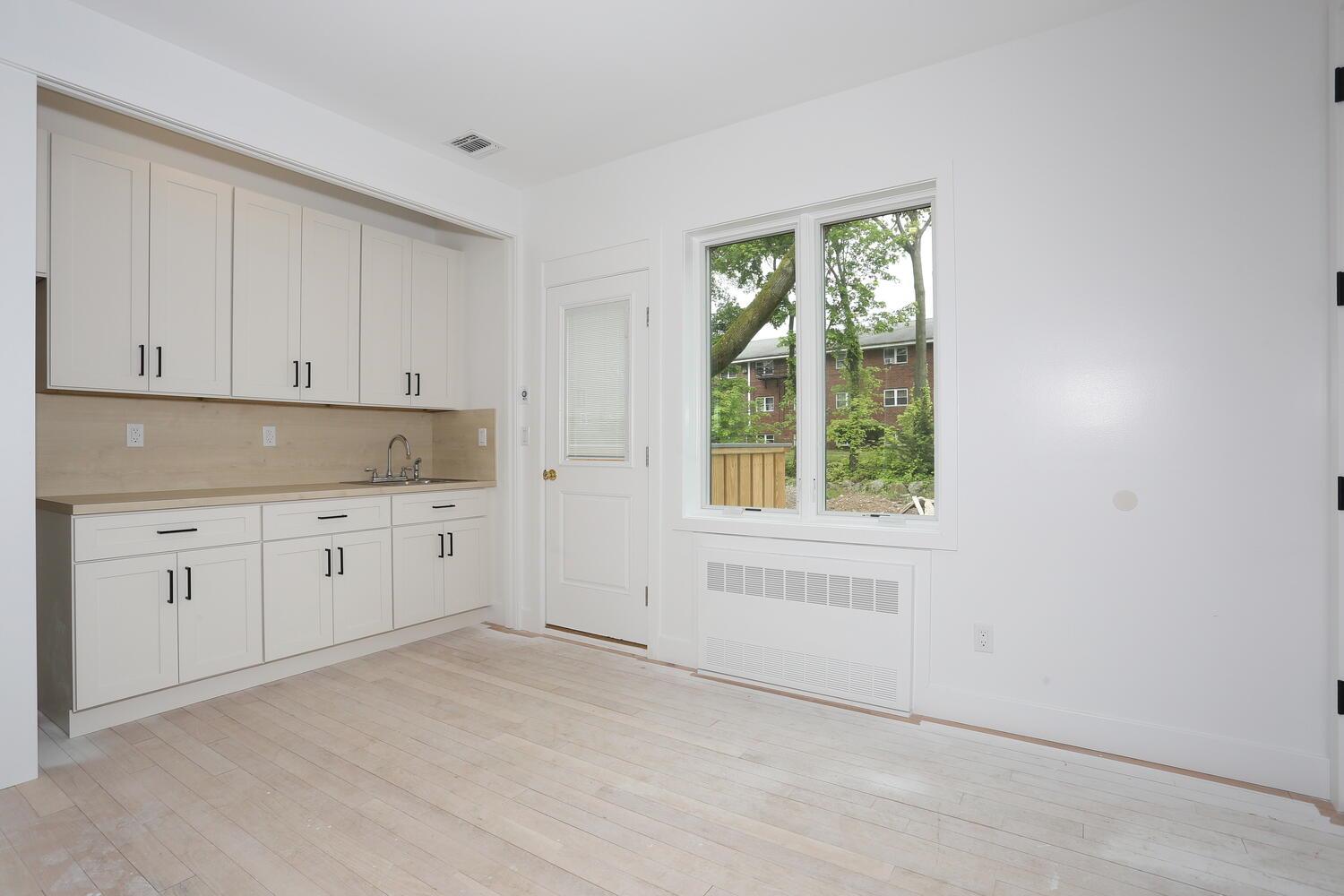 37 Ewing Avenue, Unit 202 Spring Valley, NY 10977 - Photo 15 of 44 a kitchen with white cabinets and window