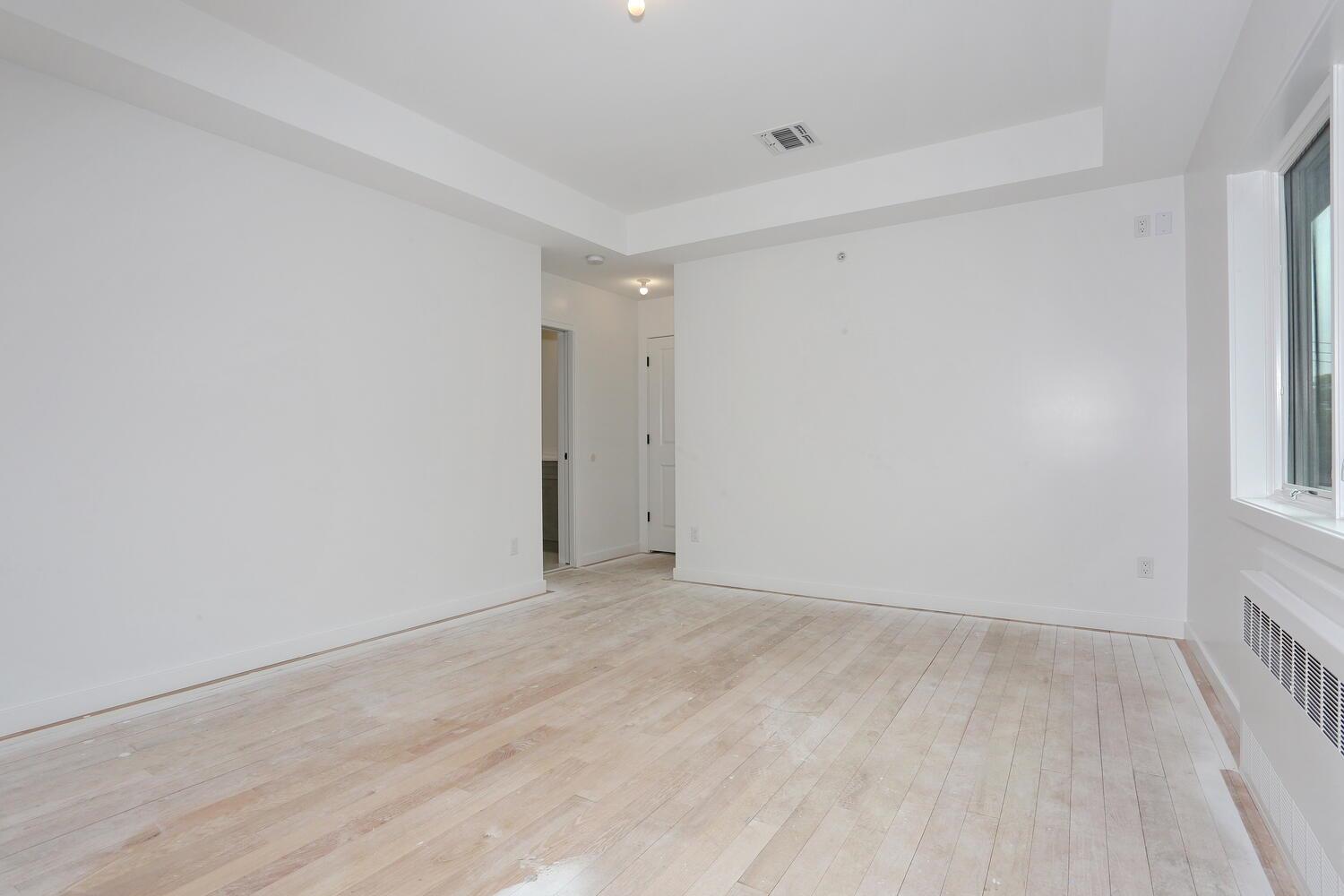 37 Ewing Avenue, Unit 202 Spring Valley, NY 10977 - Photo 19 of 44 a view of an empty room with wooden floor and a window