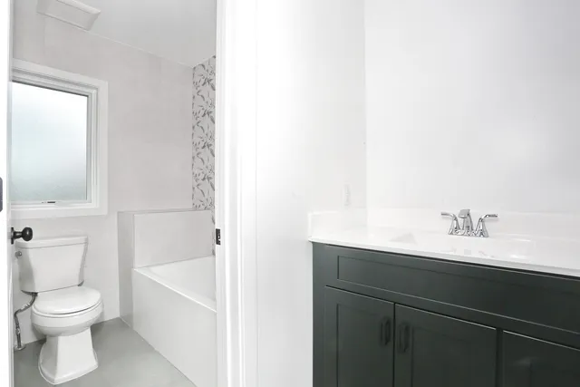 a bathroom with a toilet a sink and bathtub