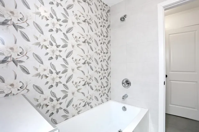 a bathroom with a bathtub and shower