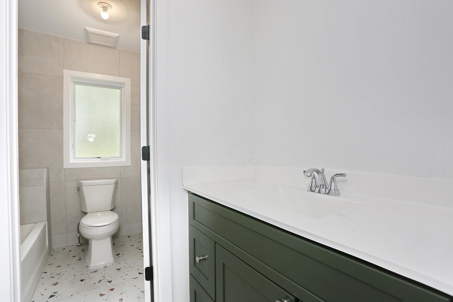 37 Ewing Avenue, Unit 202 Spring Valley, NY 10977 - Photo 28 of 44 a bathroom with a sink a toilet and a window
