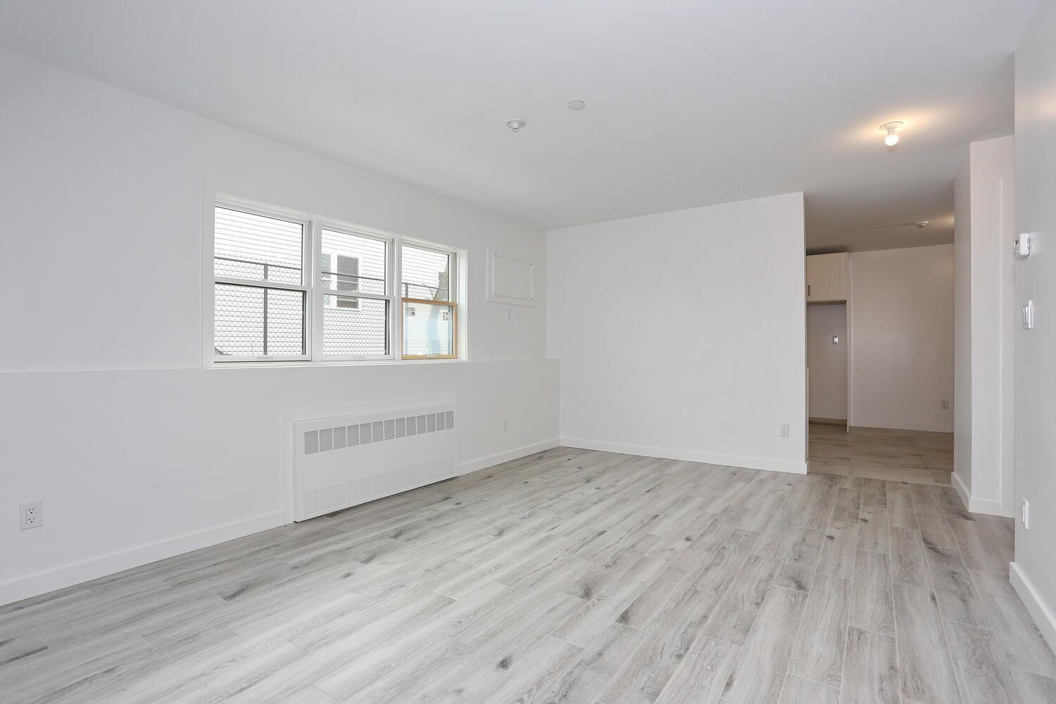 37 Ewing Avenue, Unit 202 Spring Valley, NY 10977 - Photo 31 of 44 an empty room with wooden floor and windows