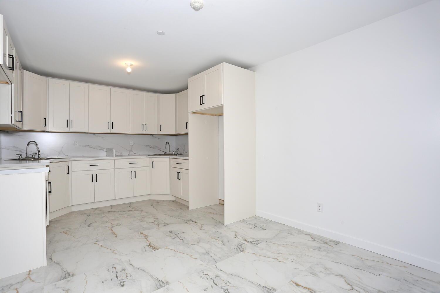 37 Ewing Avenue, Unit 202 Spring Valley, NY 10977 - Photo 33 of 44 a view of kitchen with granite countertop cabinets and white appliances