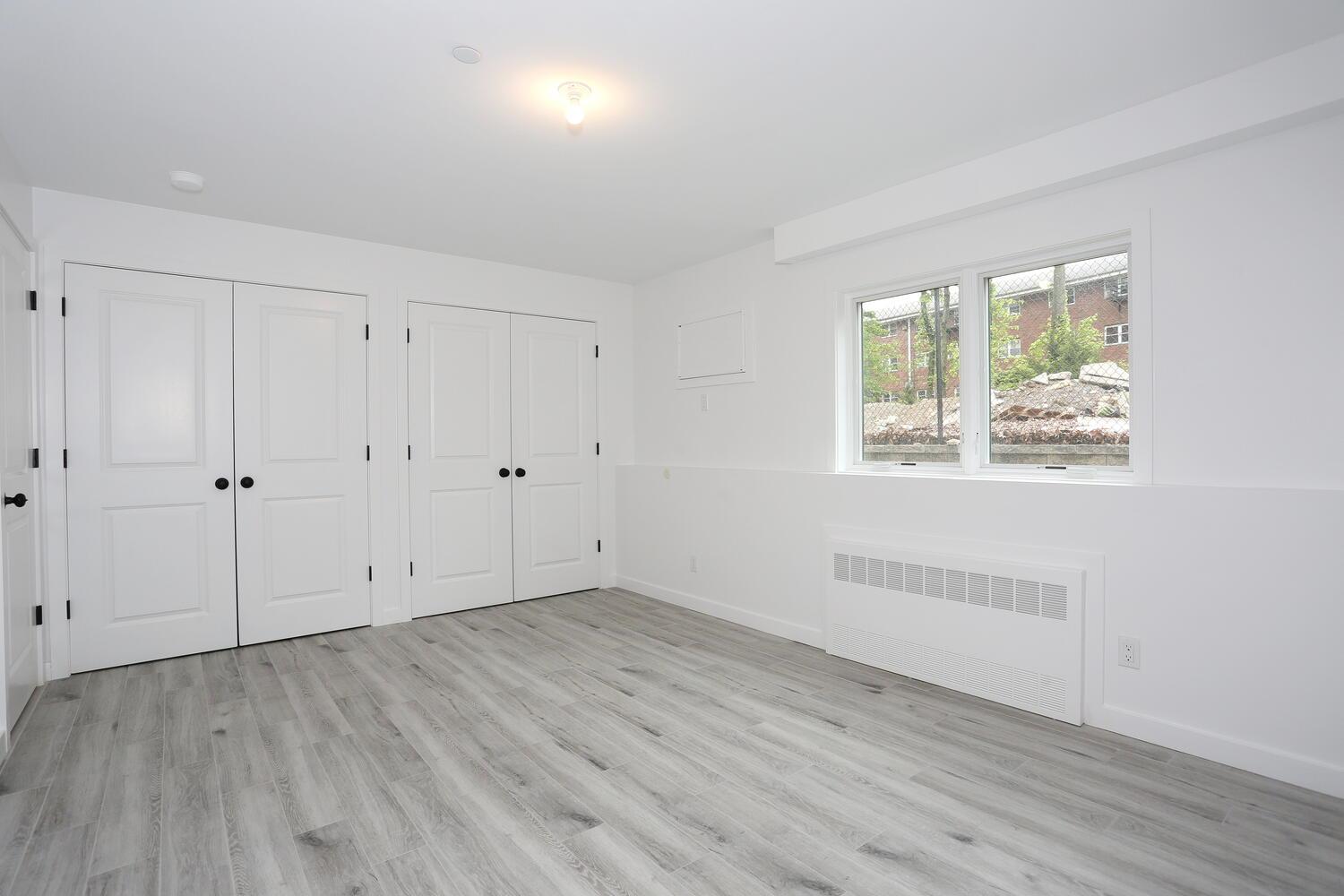 37 Ewing Avenue, Unit 202 Spring Valley, NY 10977 - Photo 37 of 44 a view of an empty room with wooden floor and a window