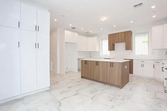 a large kitchen with a lot of counter space and a sink