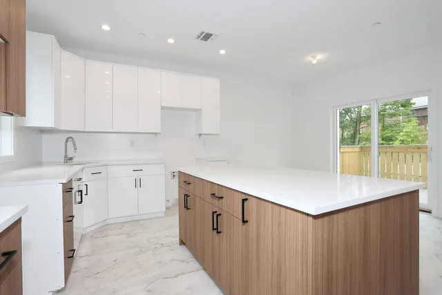 a kitchen that has a microwave a sink and a stove in it